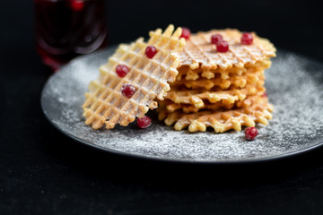Traditional Belgian waffles with fresh fruits, sprinkled with powdered sugar and cocoa. You can eat for breakfast with compote or coffee. Holiday breakfast. Copy space.  