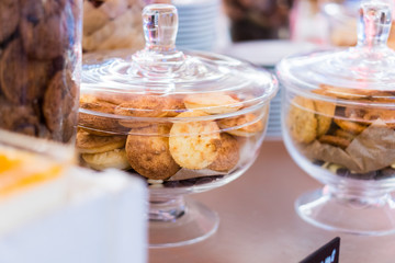 Shortbread cookies in glassware and other sweets on the buffet table during the coffee break