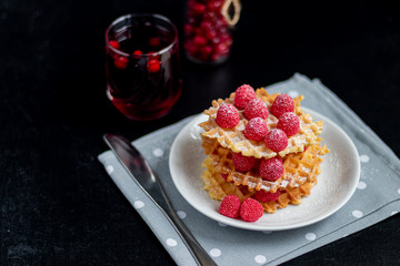 Traditional Belgian waffles with fresh fruits, sprinkled with powdered sugar and cocoa. You can eat for breakfast with compote or coffee. Holiday breakfast. Copy space.  