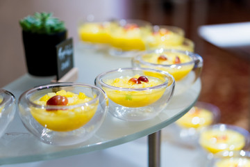 sweet desserts in glassware and other sweets on the buffet table during the coffee break.