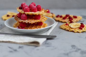 Traditional Belgian waffles with fresh fruits, sprinkled with powdered sugar and cocoa. You can eat for breakfast with compote or coffee. Holiday breakfast. Copy space.  