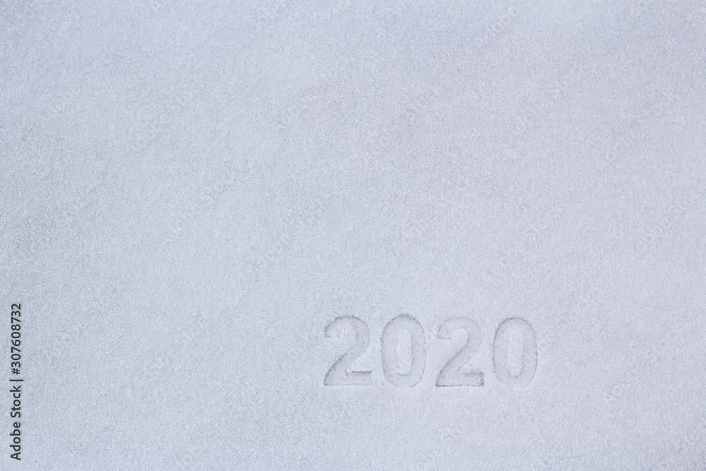 Fototapete prints of the numbers two thousand and twenty in the snow, as a symbol of the coming new year.