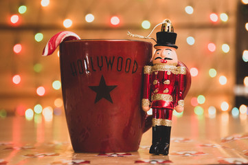 christmas background with nutcracker and cup of tea