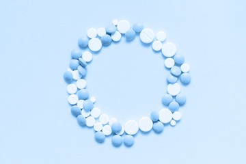 Classic blue colorful chocolate candies isolated on neo mint background. Heap of candies multi colored against a neo mint texture. Top view or flat lay. Color of the year 2020. Main trend