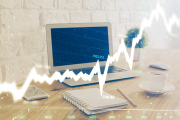 Naklejka premium Forex Chart hologram on table with computer background. Double exposure. Concept of financial markets.