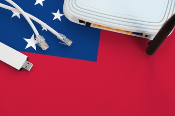 Samoa flag depicted on table with internet rj45 cable, wireless usb wifi adapter and router....