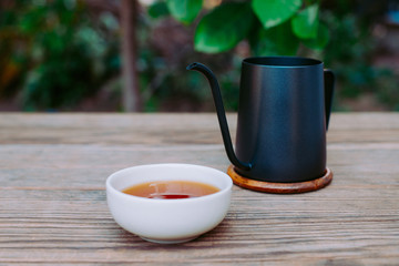 Country hot tea, Teacup placed on a wooden table, Close-up