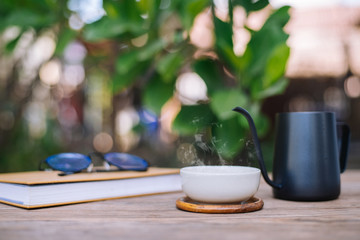 Garden reading table, Teacup placed on wooden table, Close-up