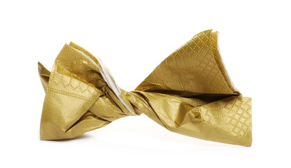 Crumpled golden paper napkin, serviette isolated on white background