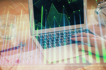 Multi exposure of market chart with man working on computer on background. Concept of financial analysis.