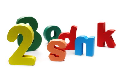 Colorful wooden alphabet, spelling and number blocks, isolated on white background