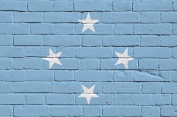Micronesia flag depicted in paint colors on old brick wall. Textured banner on big brick wall...