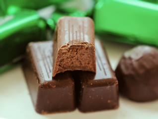 Chocolate candy with bite coated with a rich chocolate shell