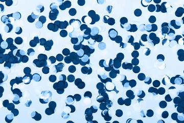 Blue shade confetti on paper background. Main color trend for 2020 year.