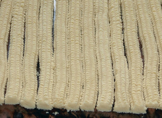 Background unbaked cookies on a table, process manufacturing with hand machine,