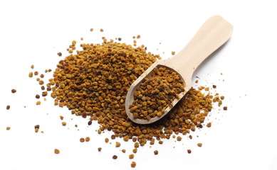Propolis, pollen pile with wooden spoon, isolated on white background