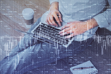 Forex graph with businessman working on computer in office on background. Concept of analysis....