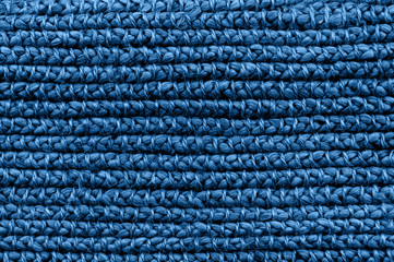 Rustic natural wicker texture toned in classic blue monochrome color. Braided pattern macro...