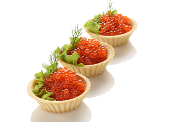 red caviar in dough tartlets with green salad on a white background