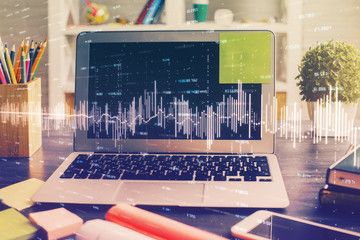 Double exposure of chart and financial info and work space with computer background. Concept of...