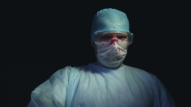 Drops of blood splattered on the surgeon's glasses during surgery. Fatal error. Save a life or kill concept. Successful or unsuccessful outcome of the operation