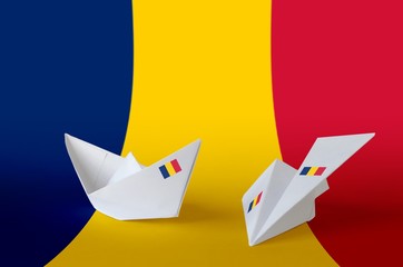 Chad flag depicted on paper origami airplane and boat. Handmade arts concept