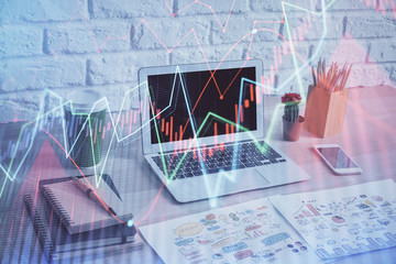 Forex market graph hologram and personal computer on background. Multi exposure. Concept of investment.