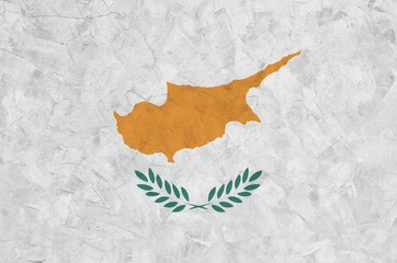 Cyprus flag depicted in bright paint colors on old relief plastering wall. Textured banner on rough...