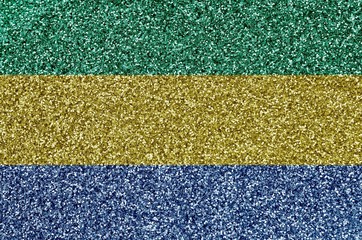 Gabon flag depicted on many small shiny sequins. Colorful festival background for party