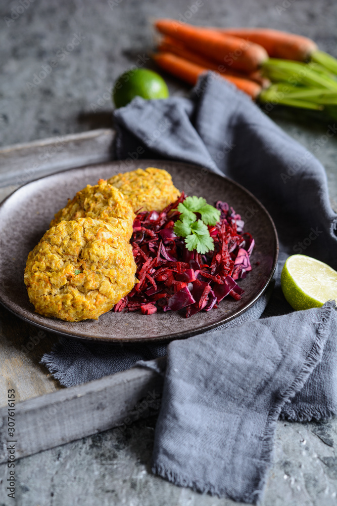 Wall mural Fritters made from red lentils, carrot and rolled oats served with red onion and cabbage - Wall murals