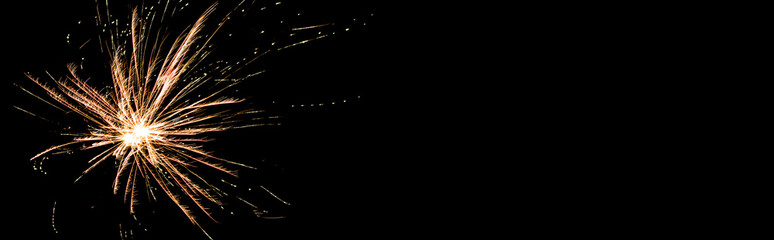 Panoramic shot of orange festive firework, isolated on black