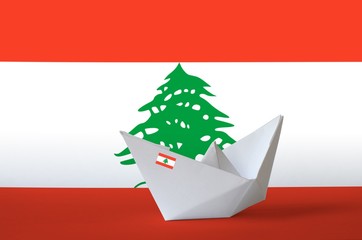 Lebanon flag depicted on paper origami ship closeup. Handmade arts concept
