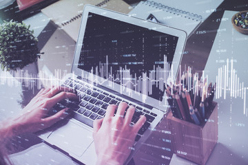 Double exposure of businessman's hands withcup of coffee with stock market graph background. Concept of research and trading.