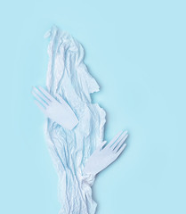 paper texture and paper hands on pastel blue background. abstract artistic image. creative minimalistic concept design. soft selective focus