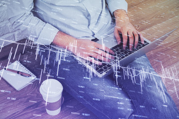 Double exposure of businessman's hands withcup of coffee with stock market graph background. Concept of research and trading.