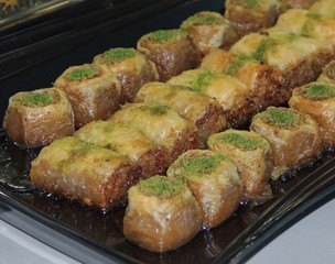 Arabic pastry cake  with pistachio powder in baking tray