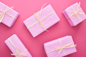 top view of gift boxes with bows on pink