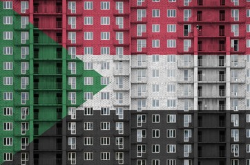 Sudan flag depicted in paint colors on multi-storey residental building under construction....