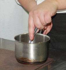 Chef Stirring food in a commercial  kitchen in Serbia