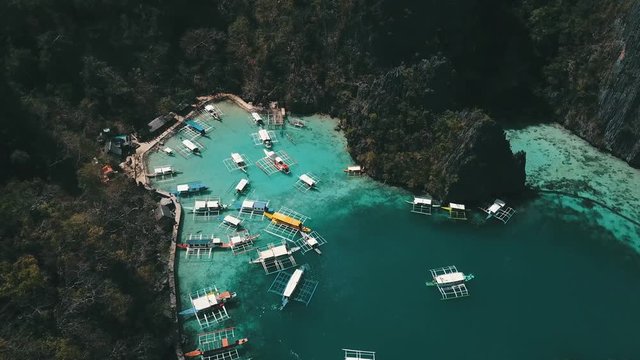 approaching a small port on the island with many Banca boats