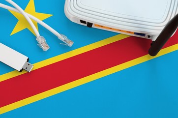 Democratic Republic of the Congo flag depicted on table with internet rj45 cable, wireless usb wifi...