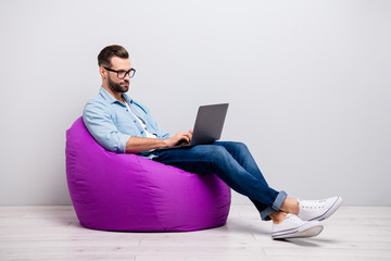 Full length profile photo of attractive guy holding notebook browsing chatting colleagues sitting...