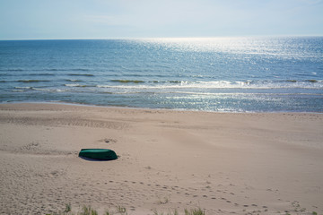 Fototapeta na wymiar Baltic sea, empty beach and green boat, Latvia