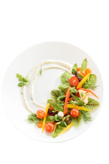micro-greens and vegetables salad on a white plate