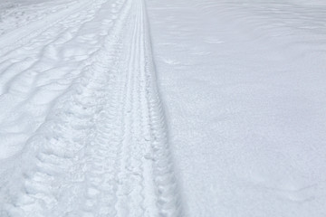 car track on pure white snow