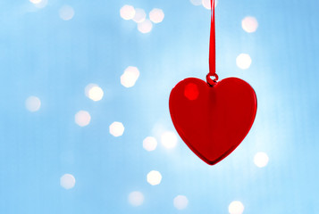 Hanging Christmas Heart toy on on a glowing colorful background