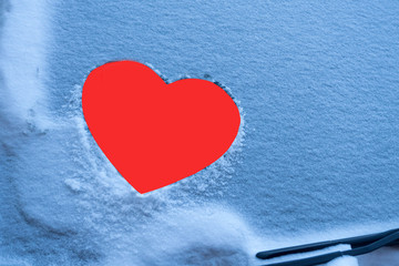Naklejka na ściany i meble image of a red heart on a frozen car windshield