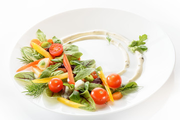 micro-greens and vegetables salad on a white plate