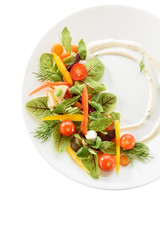micro-greens and vegetables salad on a white plate