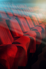Movie theater empty auditorium with red seats and blue lighting